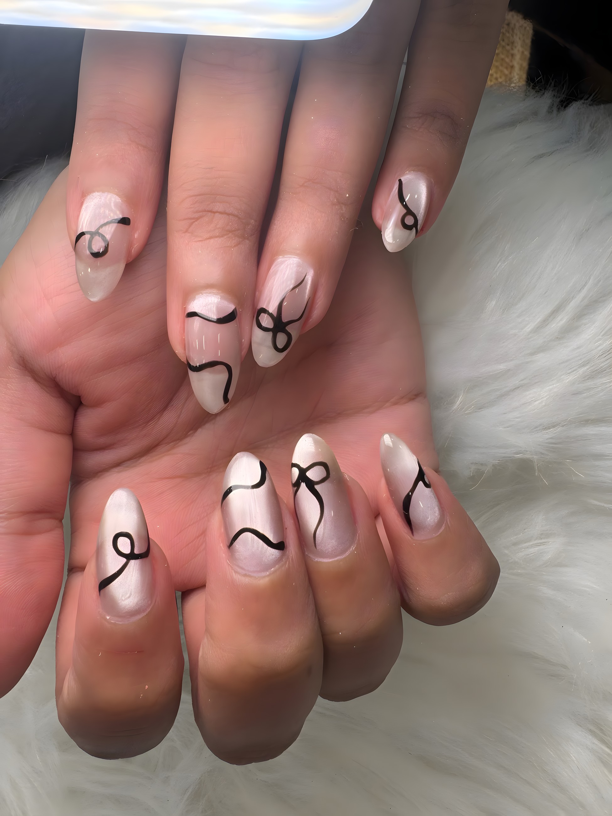 Pearl chrome nails with fine black freehand line art by LoveLe