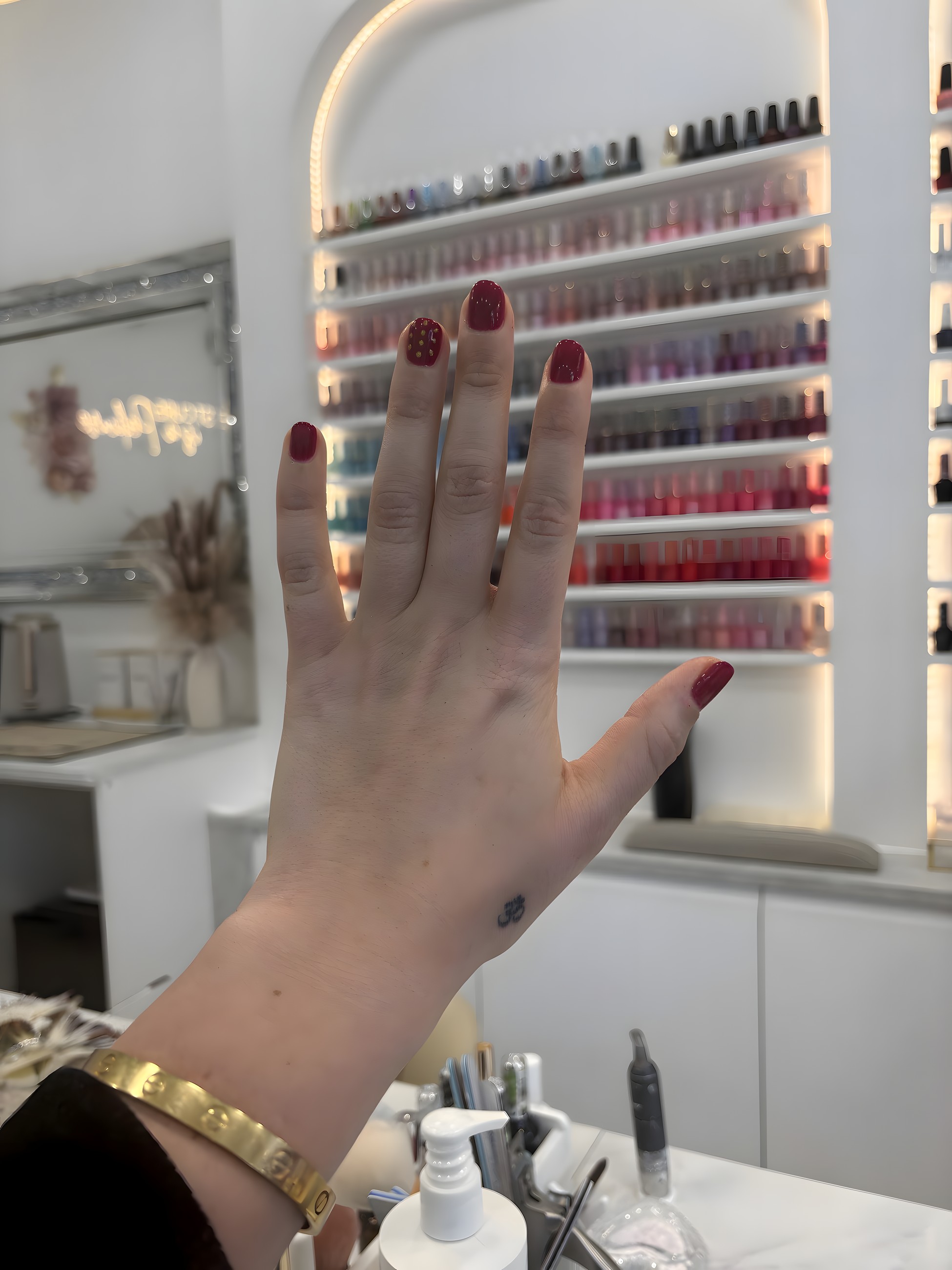 Deep red gel nails photographed in the salon